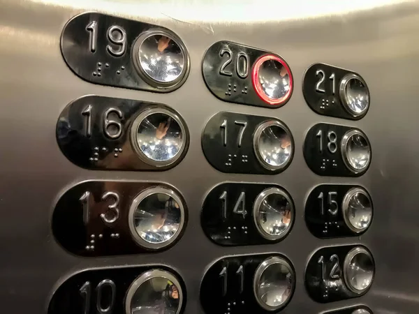 Elevator buttons with number 20 included. Elevator Keyboard made of steel monochrome stainless steel sheet. Close-up of Elevator buttons in multi-storey building. Banner with space for copying text