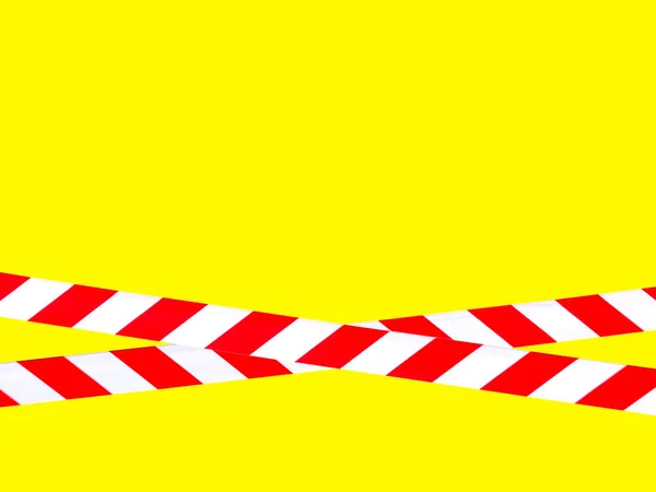 Red and white warning lines of barrier tape prohibit passage. Barrier tape on yellow isolate. Barrier that prohibits traffic. Danger unsafe area warning do not enter. Concept of no entry. Copy space
