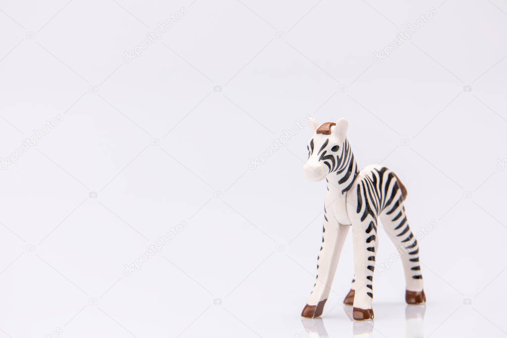 close up of a plastic stripped zebra isolated on a white background