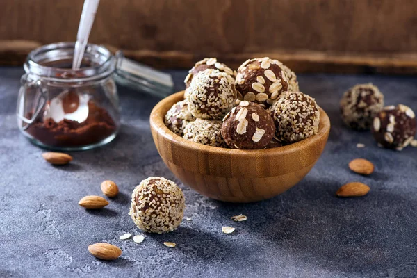 Energy balls, vegan raw sweets, homemade dessert with almond and cacao, sesam and oats