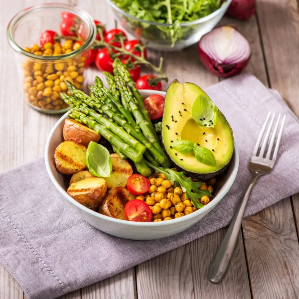 Healthy dinner with green asparagus, lentils and spicy chickpeas