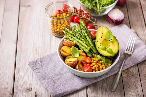 Healthy dinner with green asparagus, lentils and spicy chickpeas