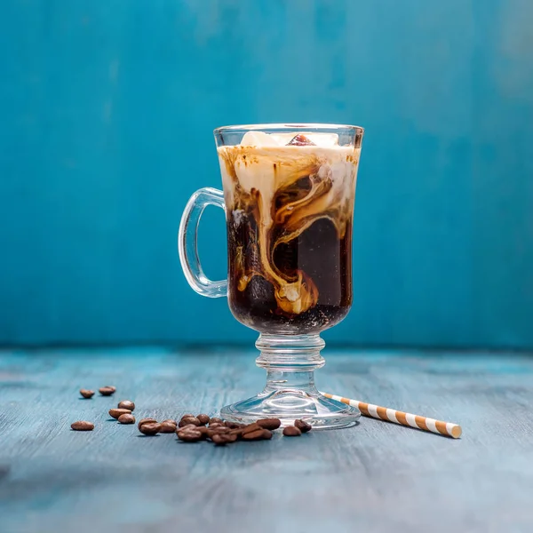 Iced coffee in a glass on blue background square — Stock Photo, Image