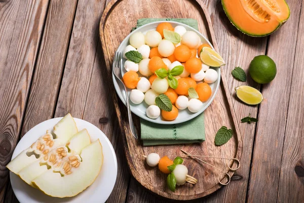 Melon and mozzarella salad appetizer or snack, summer salad with — Stock Photo, Image