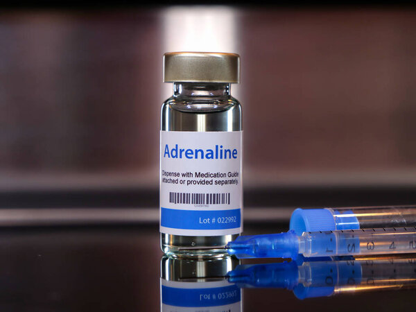vial of adrenaline injection with syringe.
