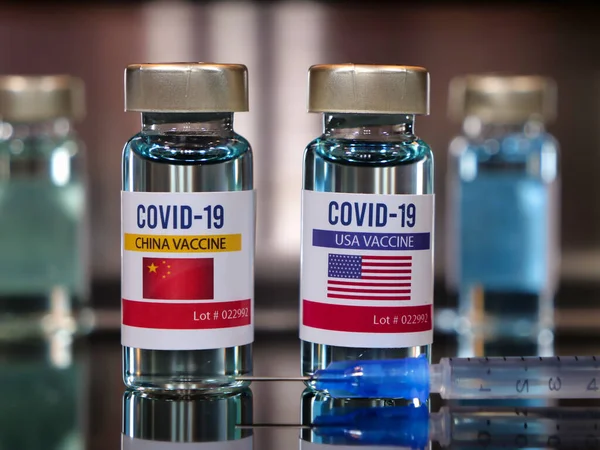 Vial of covid-19 vaccine with a flag label of USA and China