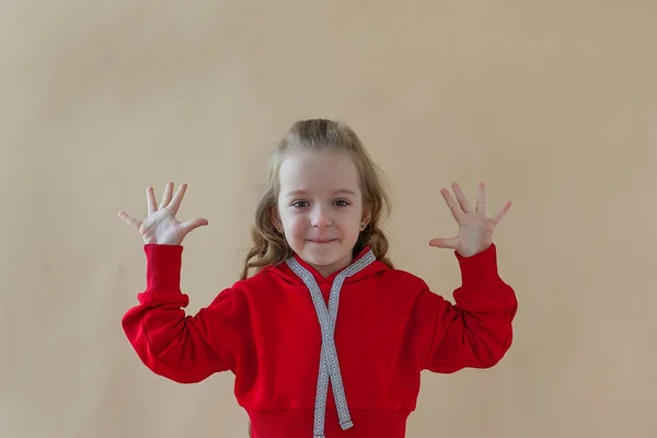 Little Blonde Curly Beautiful Girl Red Sport Costume White Sneakers — Stock Photo, Image