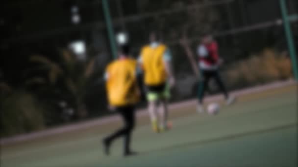 Blurred of men playing football match outdoors on night time. — Stock Video