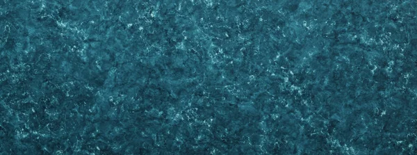 Abstract blue marbled paint splatter background resembling water waves