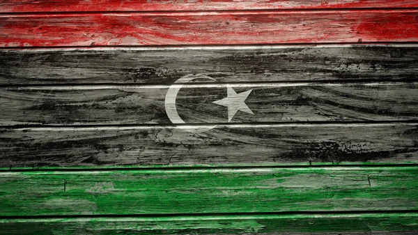 天気の良い木の板に描かれたリビアの旗 — ストック写真