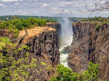 Victoria Falls Zambiya yanında, en ikonik Afrika doğal yerlerinden. Zambezi Nehri ve Zambiya ve Zimbabve kenarlığını Kanyon'da.