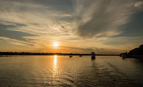 Boats cruises the Zambezi River at sunset time, the border between Zimbabwe and Zambia, Tour Boat on the Zambezi. Africa