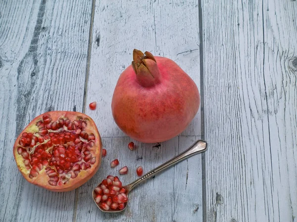 Table One Whole Pomegranate Another Cut Half Bright Red Grains — Stock Photo, Image