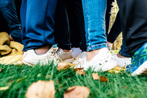 Female legs in team building in nature