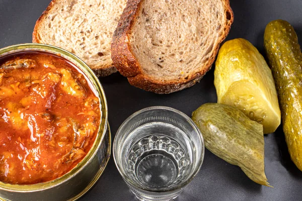 Glass with vodka, sake, sprats, pickles and bread. Snack and alcohol. — Stock Image Glass Vodka Sake Sprats Pickles Bread Snack Alcohol Royalty Free Stock Photos