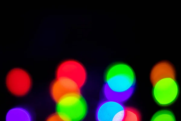 A brilliant glowing background side on black. The glitter light bokeh for the New Year and other holidays. — Stock Photo, Image