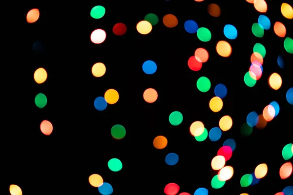 Un brillant fond lumineux côté noir. Le bokeh léger paillettes pour le Nouvel An et d'autres vacances. — Photo