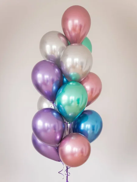 multicolored balloons on a light background. vertical orientation