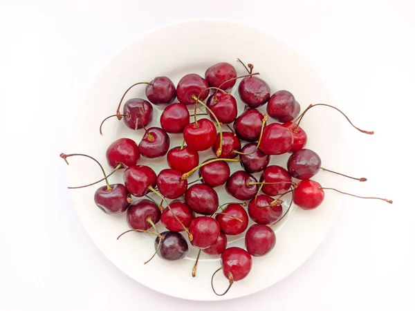 Cherries on a white background. Berries on a white plate. Selective focus — Stock Photo, Image
