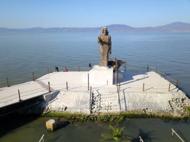 Chapala, Mexico - May 19 2019: Frontal aerial view of the statue of Cristo Pescador at Lake Chapala clipart