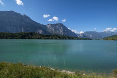 Cavedine Gölü Trentino. Turkuaz mavi su manzarası. Bir yaz günü dağlar ve bitki örtüsüyle birlikte. Lago di Cavedine, Güney Tyrol, İtalya 'da bulunan küçük bir alp gölüdür.