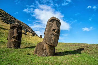 Moai statues in the Rano Raraku Volcano in Easter Island, Chile with blue sky clipart