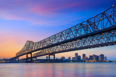 The crescent city connection bridge on the mississippi river and downtown new orleans louisiana clipart