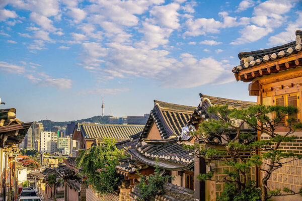 Bukchon Hanok Village with Seoul city skyline, cityscape of South Korea at sunset