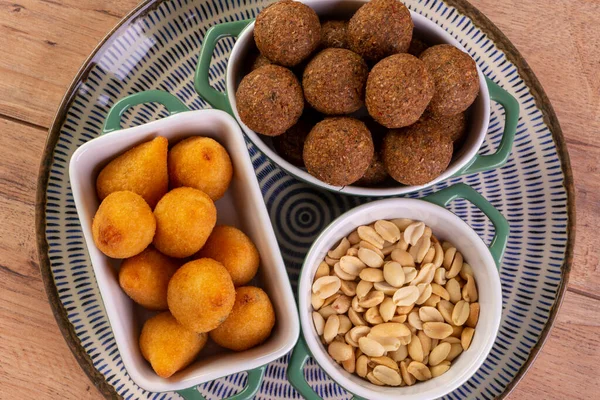 Mix of fried savory snack with coxinha, kebab and roasted and salted peanuts.