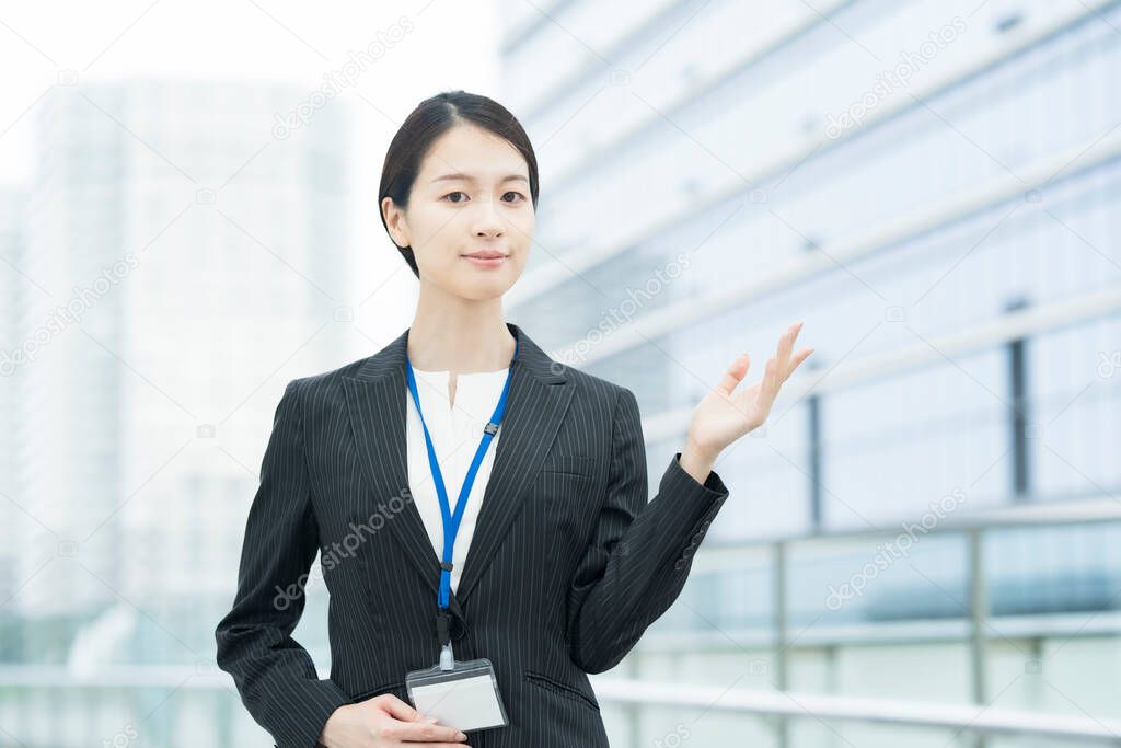 A young Asian business woman in a suit posing for guidance and peace of mind