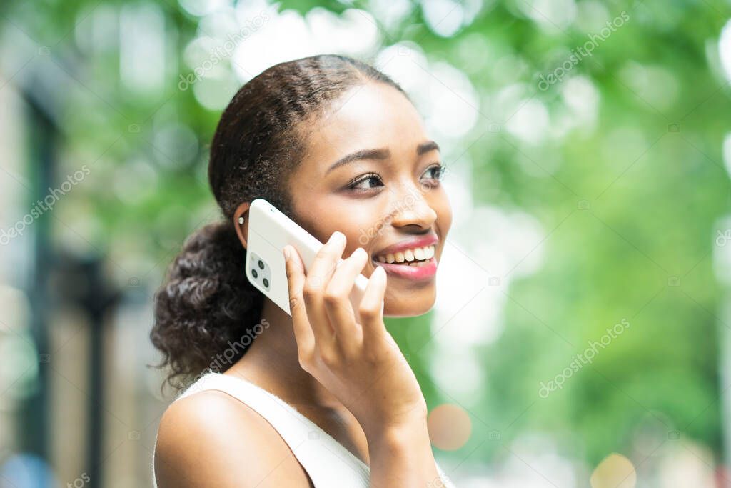 Young business woman calling by putting a smartphone on the ear