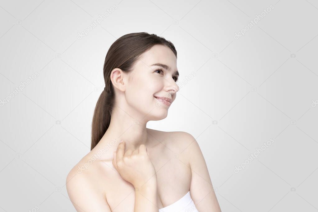 Asian young woman touching face with her hand in relaxed expression