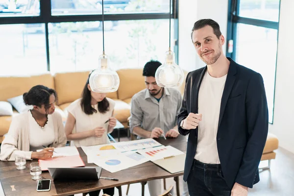 International business team with a businessman posing in the office