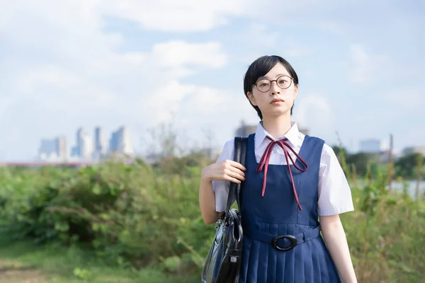 Asian high school girl with short black hair wearing glasses