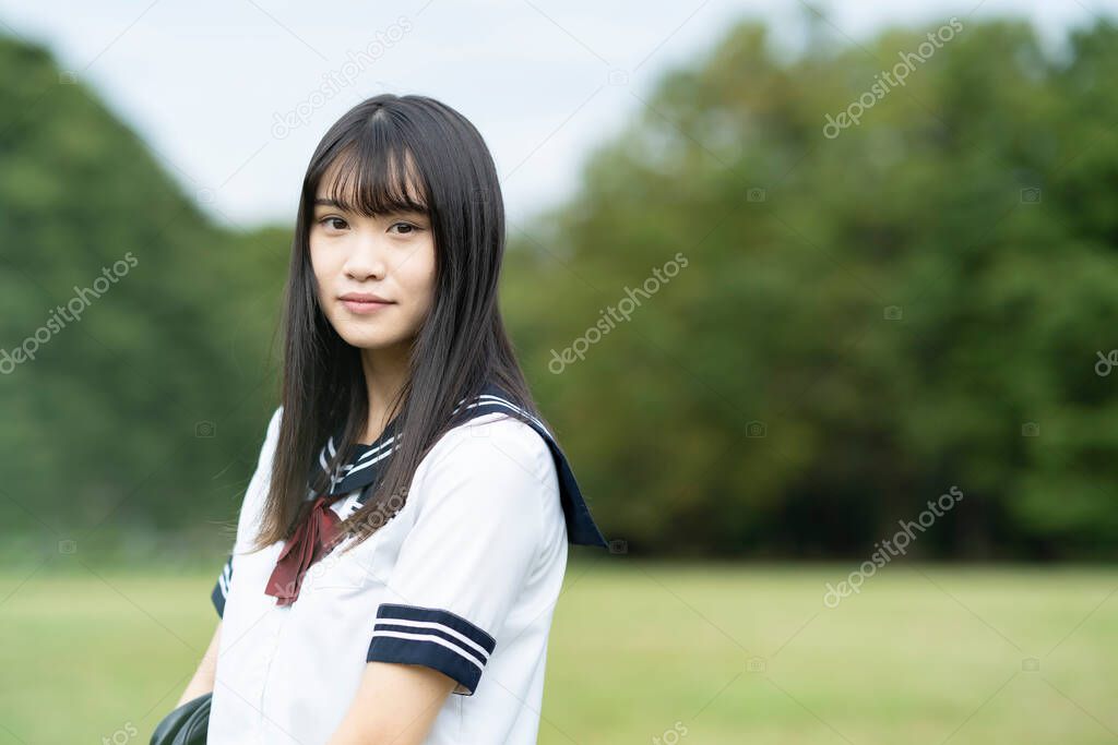 female asian high school student with a calm look outdoors