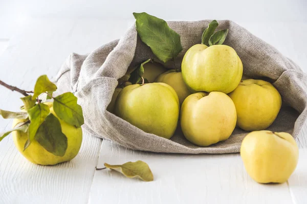 Rijpe Kweeperen Die Uit Een Linnen Zak Rollen Witte Houten — Stockfoto