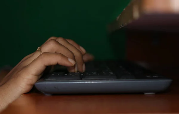 Keyboard typing. Hand typing on desktop office computer keyboard. Woman using computer.