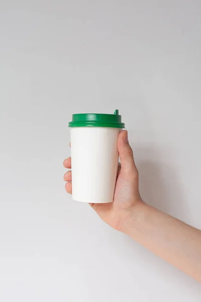 Take away coffee cup background. Male hand holding a coffee paper cup