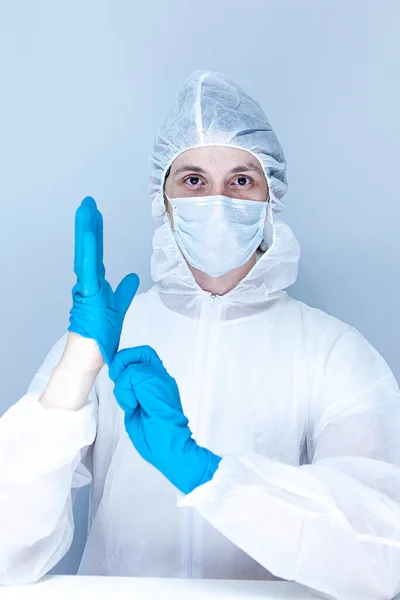a man in a protective suit, gloves and face mask. The concept of health care.