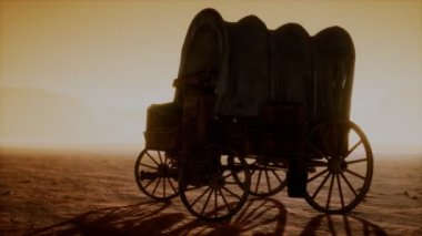 Çölde gün batımında eski arabaları kaplayan tuval.