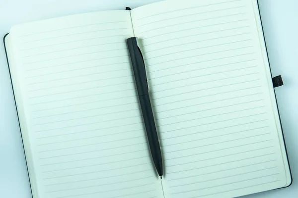 Άνοιγμα Λευκού Σημειωματάριο Χαρτί Και Στυλό Στο Φως Φόντο Πίνακα — Φωτογραφία Αρχείου