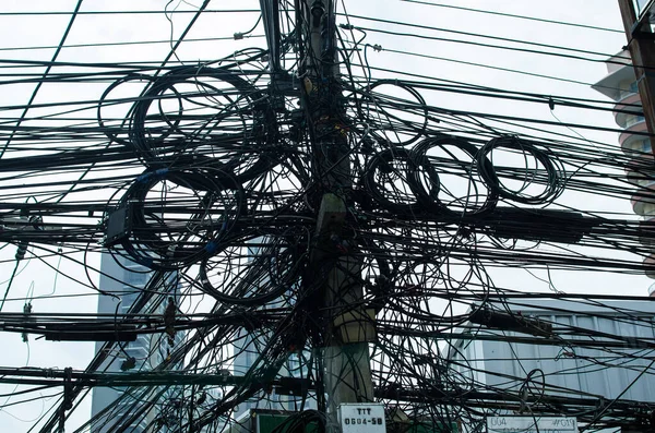 The chaos of cables and tangled wires on every street in Thailand.