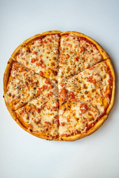 Вкусная пицца Маргарита на выпечке бумаги на светлом столе Вертикальный вид сверху.