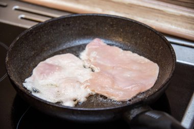 Tavada yağda kızartılmış tavuk fileto.