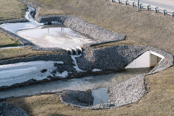 Drainage system for the highway reinforced with stones