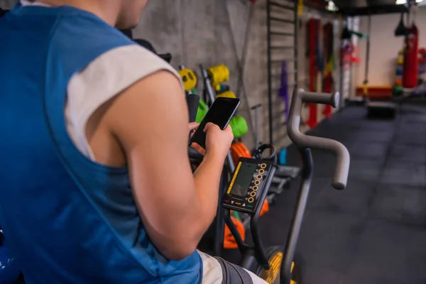 Jeune Homme Faisant Exercice Seul Intérieur Utilisant Son Téléphone Portable — Photo