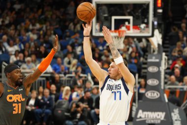 Dallas Mavericks player Luka Doncic #77 shoots a three during the game at the Amway Center in Orlando Florida on Friday February 21, 2020.  clipart