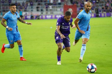 Orlando City 'den Ruan (2), 10 Temmuz Çarşamba günü Floria' nın Orlando kentindeki Exploria Stadyumu 'nda oynanan ABD Açık Kupası' nda NYC FC defans oyuncularını geçiyor.,  