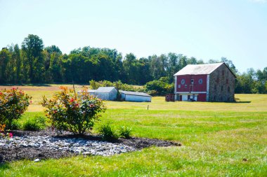 View an old brick house on the meadow clipart