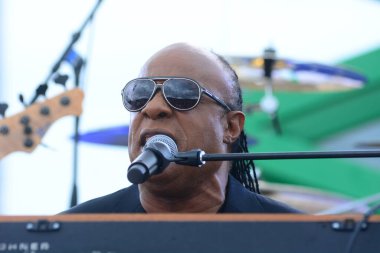 Stevie Wonder performs at a Rally held by President Barack Obama in Support of Hillary Clinton's bid for President on November 6, 2016 in Kissimmee Florida. clipart